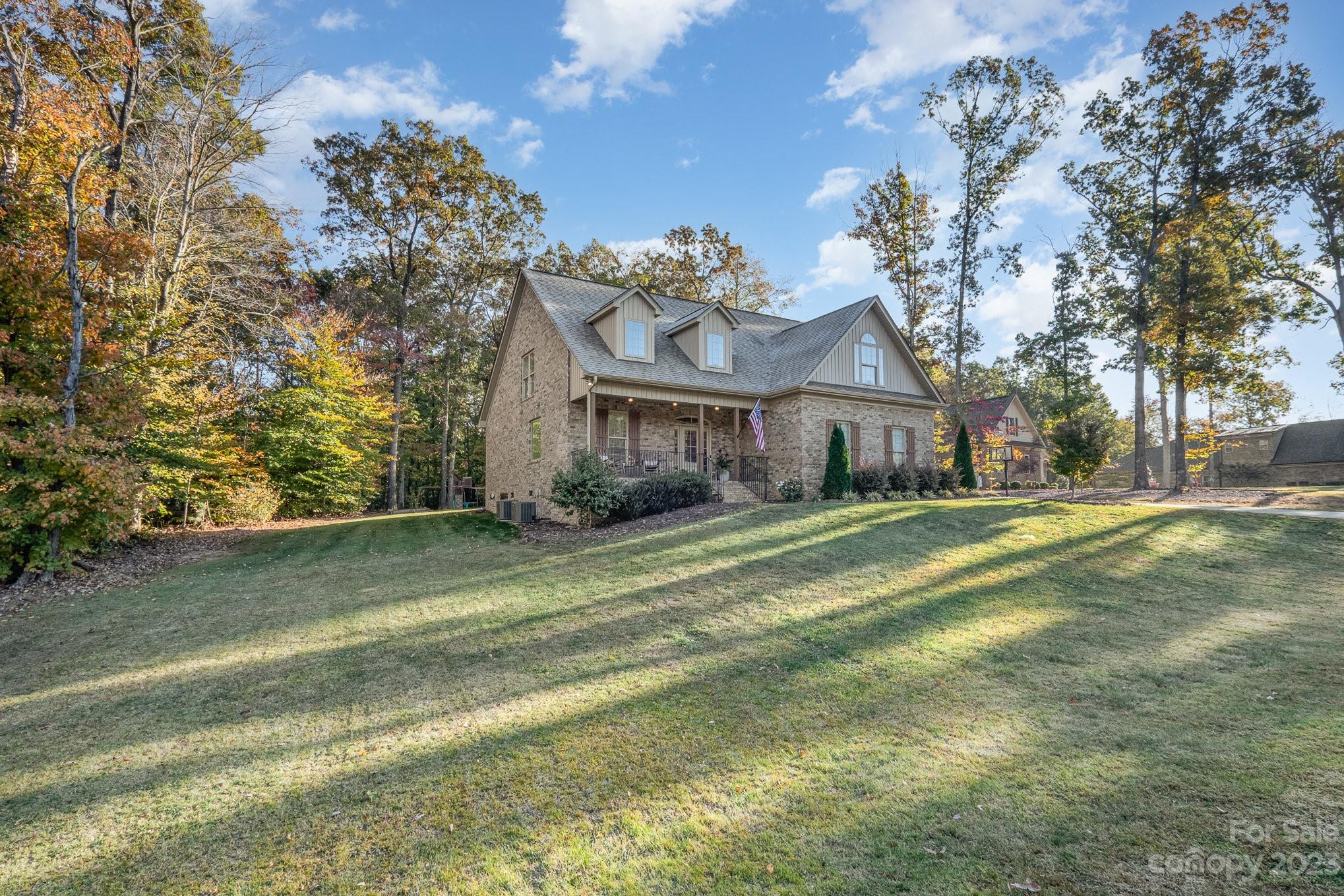 1007 Flat Rock Drive Monroe, NC 28110 - Photo 2 of 34 a front view of a house with a big yard and a large tree