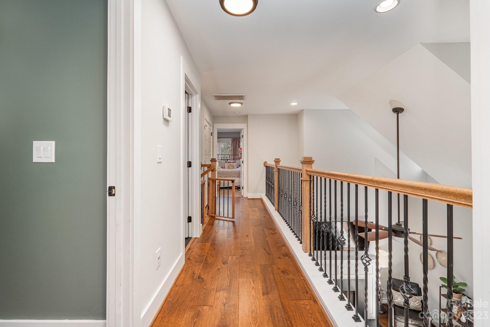 1007 Flat Rock Drive Monroe, NC 28110 - Photo 23 of 34 a view of a hallway with wooden floor and staircase