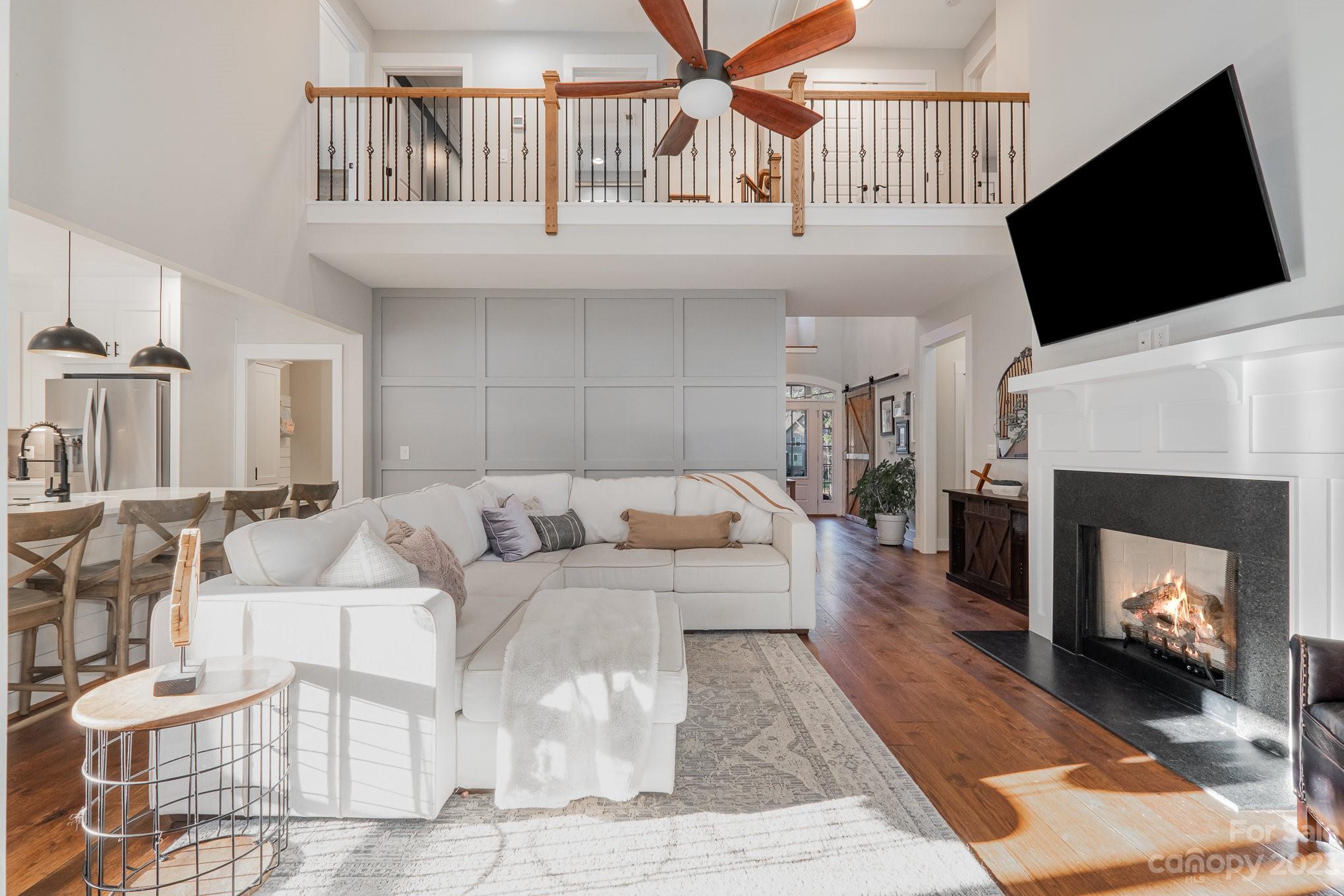1007 Flat Rock Drive Monroe, NC 28110 - Photo 7 of 34 a living room with furniture a flat screen tv and a fireplace