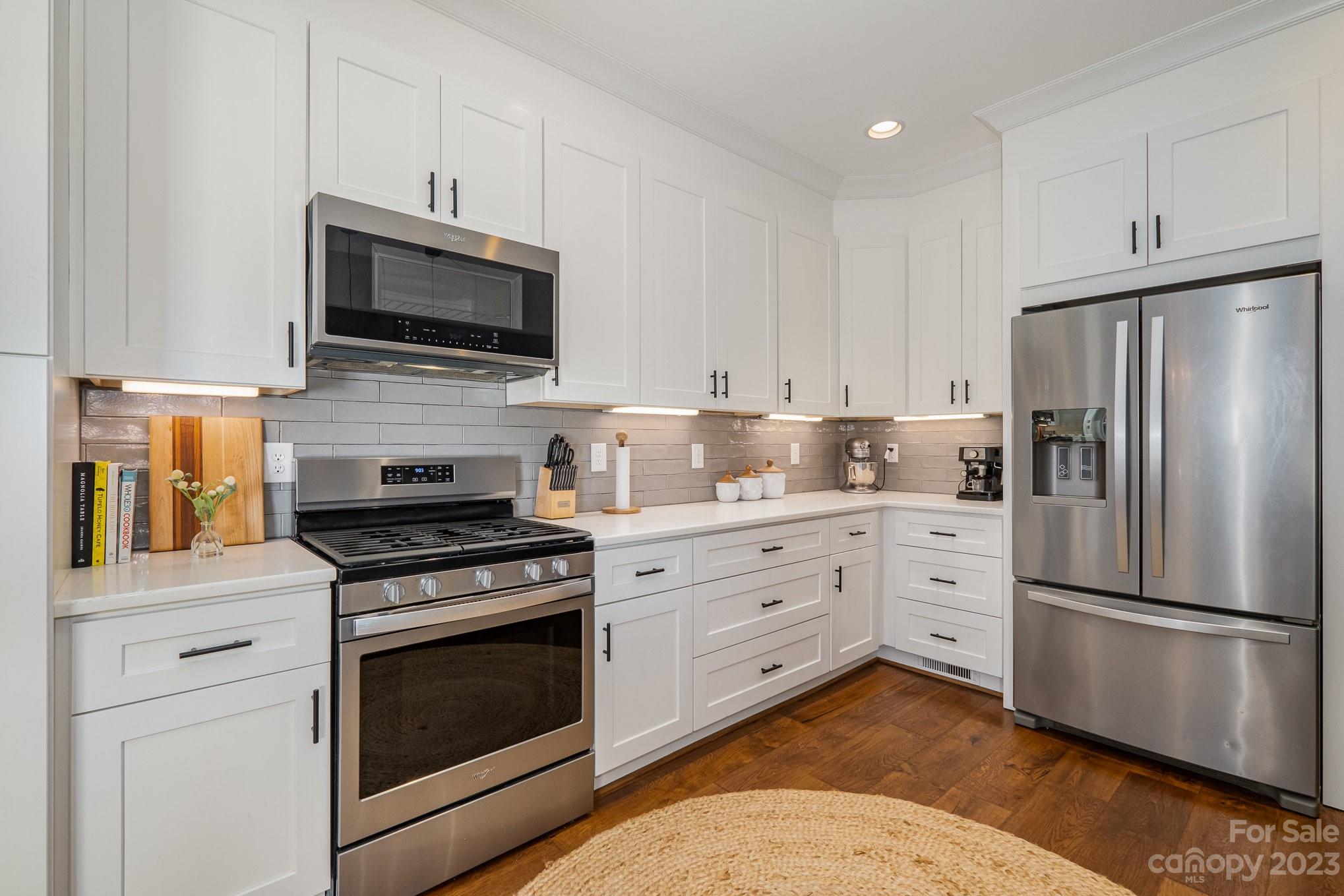 1007 Flat Rock Drive Monroe, NC 28110 - Photo 10 of 34 a kitchen with white cabinets and stainless steel appliances