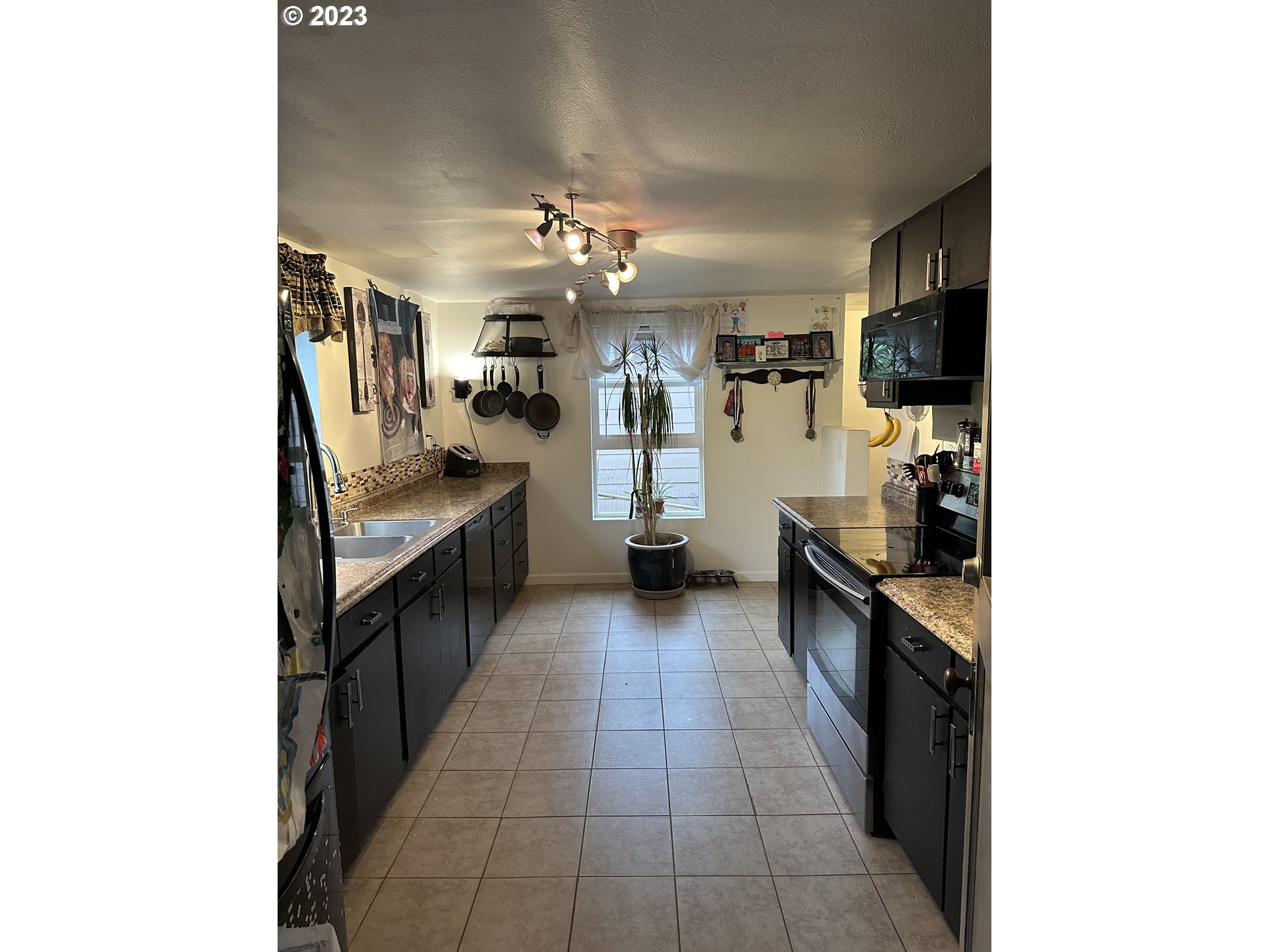 1601 7th Street Springfield, OR 97477 - Photo 4 of 16 a large kitchen with cabinets and stainless steel appliances