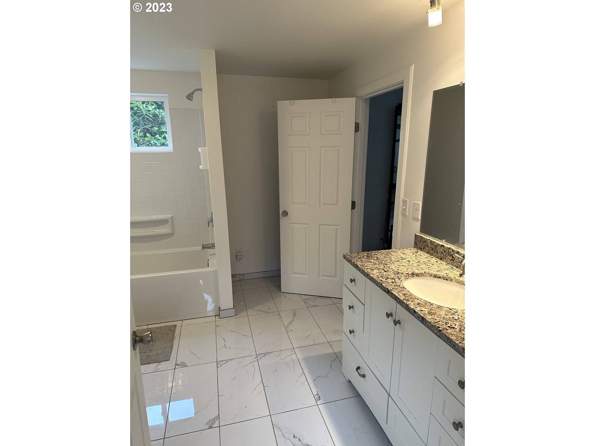 1601 7th Street Springfield, OR 97477 - Photo 10 of 16 a bathroom with a granite countertop sink and a mirror