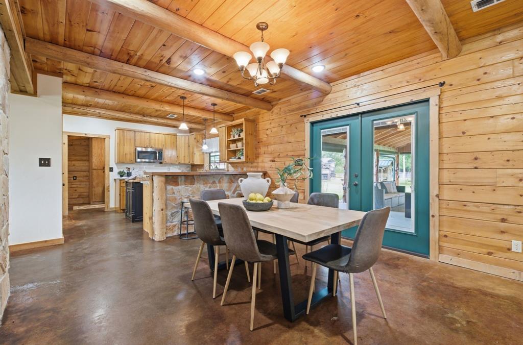 465 Emberson Ranch Road Pilot Point, TX 76258 - Photo 8 of 40 a view of a dining room with furniture and a chandelier