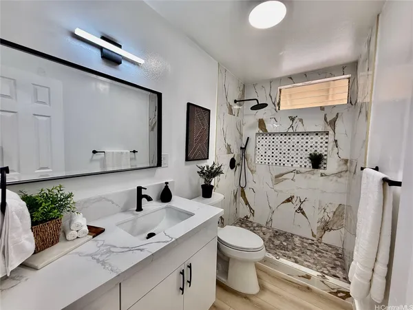 a bathroom with a sink toilet and shower