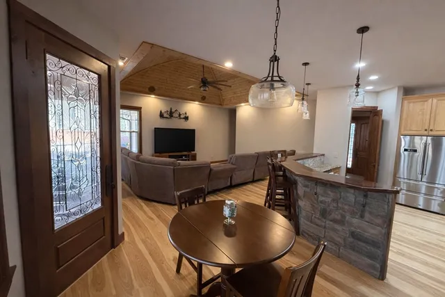 a kitchen with stainless steel appliances granite countertop a sink a stove and a refrigerator