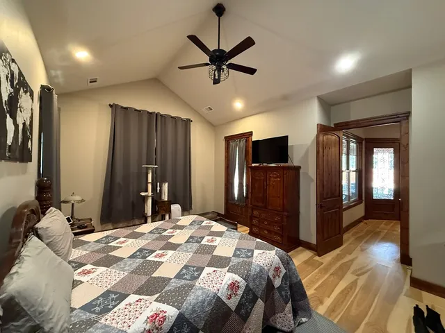 a bedroom with a bed and a large mirror with a flat tv screen