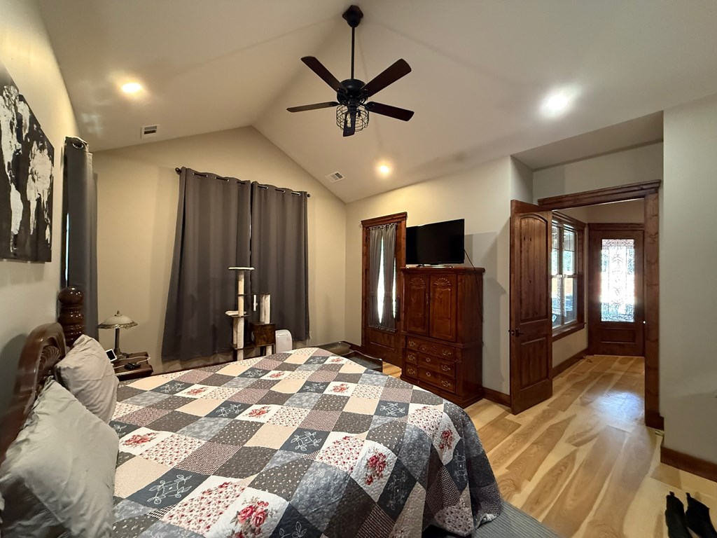 3331 Gumlog Road Young Harris, GA 30582 - Photo 22 of 39 a bedroom with a bed and a large mirror with a flat tv screen