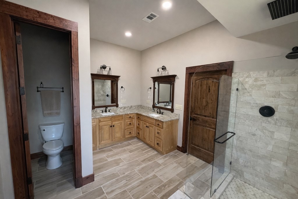 3331 Gumlog Road Young Harris, GA 30582 - Photo 23 of 39 a spacious bathroom with a granite countertop sink a toilet and shower