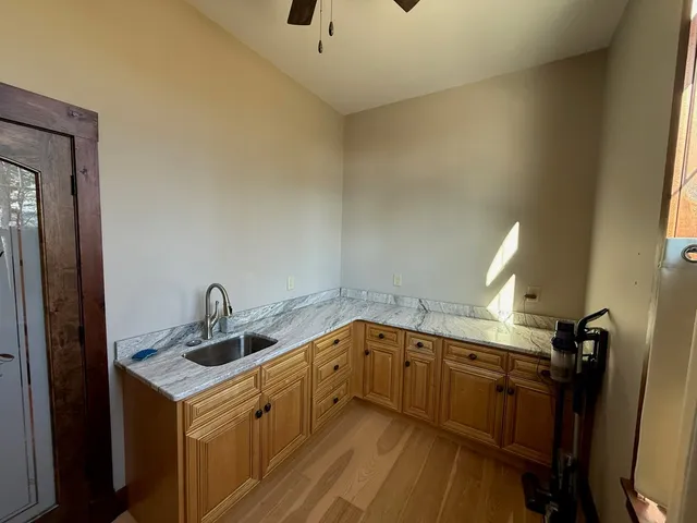 a kitchen with a sink a stove and cabinets