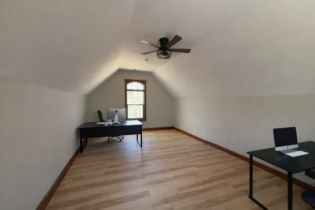 a view of a workspace with wooden floor
