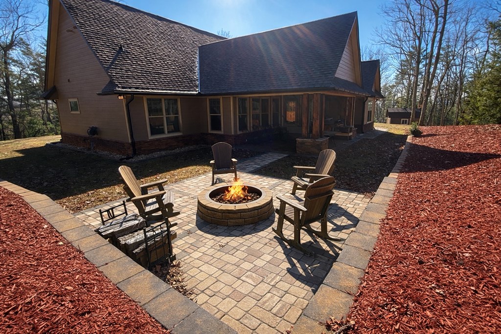 3331 Gumlog Road Young Harris, GA 30582 - Photo 5 of 39 a view of a patio with table and chairs barbeque grill and wooden fence