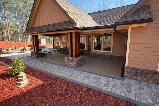 a view of a house with backyard porch and sitting area