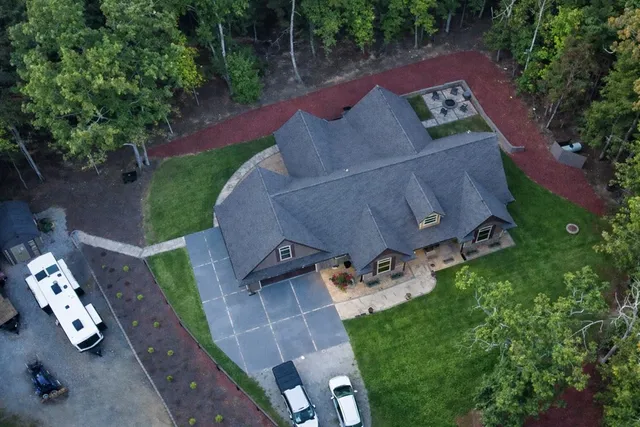 an aerial view of a house with garden space and street view