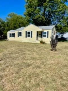 a backyard of a house with large trees