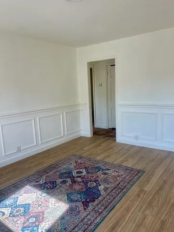 a view of wooden floor and cabinet in a room