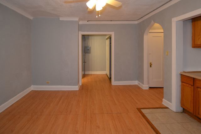 4735 North Beacon Street, Unit 307 Chicago, IL 60640 - Photo 11 of 15 a view of an empty room with wooden floor and a window