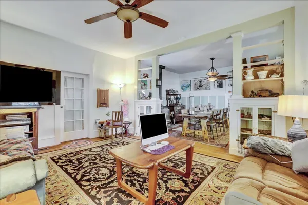 a living room with furniture and wooden floor