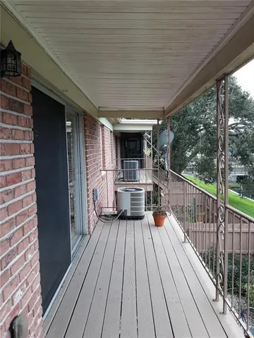 a view of a balcony with wooden floor