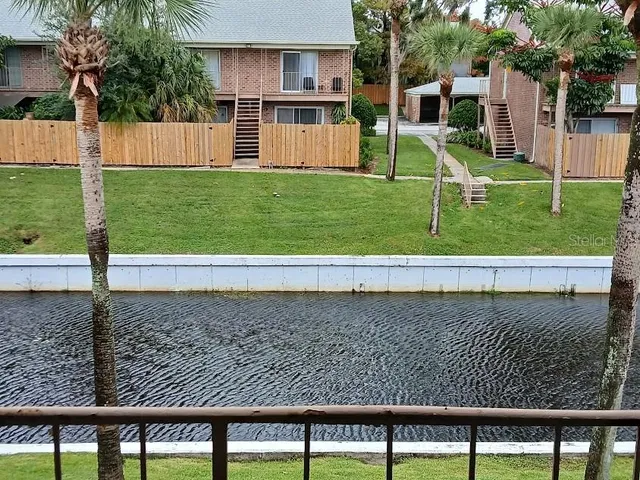 a view of a backyard with plants and patio