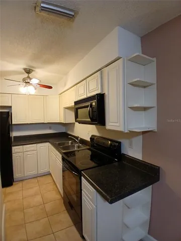 a kitchen with a sink stove and microwave