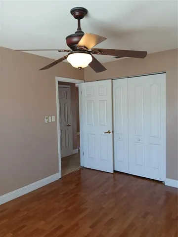a view of room with a chandelier fan and wooden floor
