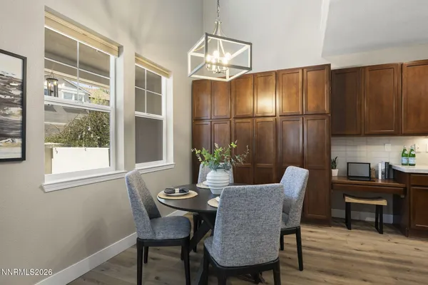 a kitchen with stainless steel appliances granite countertop a sink a stove a refrigerator cabinets and chairs