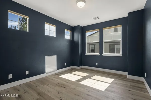 an empty room with wooden floor