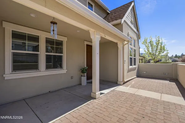 a view of backyard with large window and wooden fence