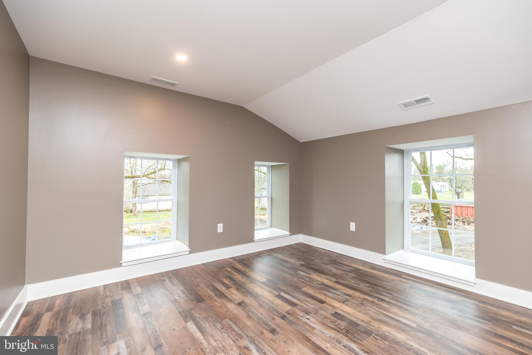 4844 Old Easton Road, Unit 2 Doylestown, PA 18902 - Photo 11 of 33 a view of an empty room with wooden floor and a window