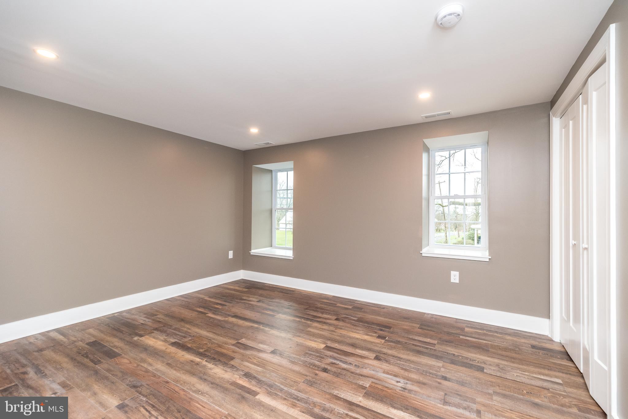 4844 Old Easton Road, Unit 2 Doylestown, PA 18902 - Photo 14 of 33 a view of empty room with wooden floor and fan