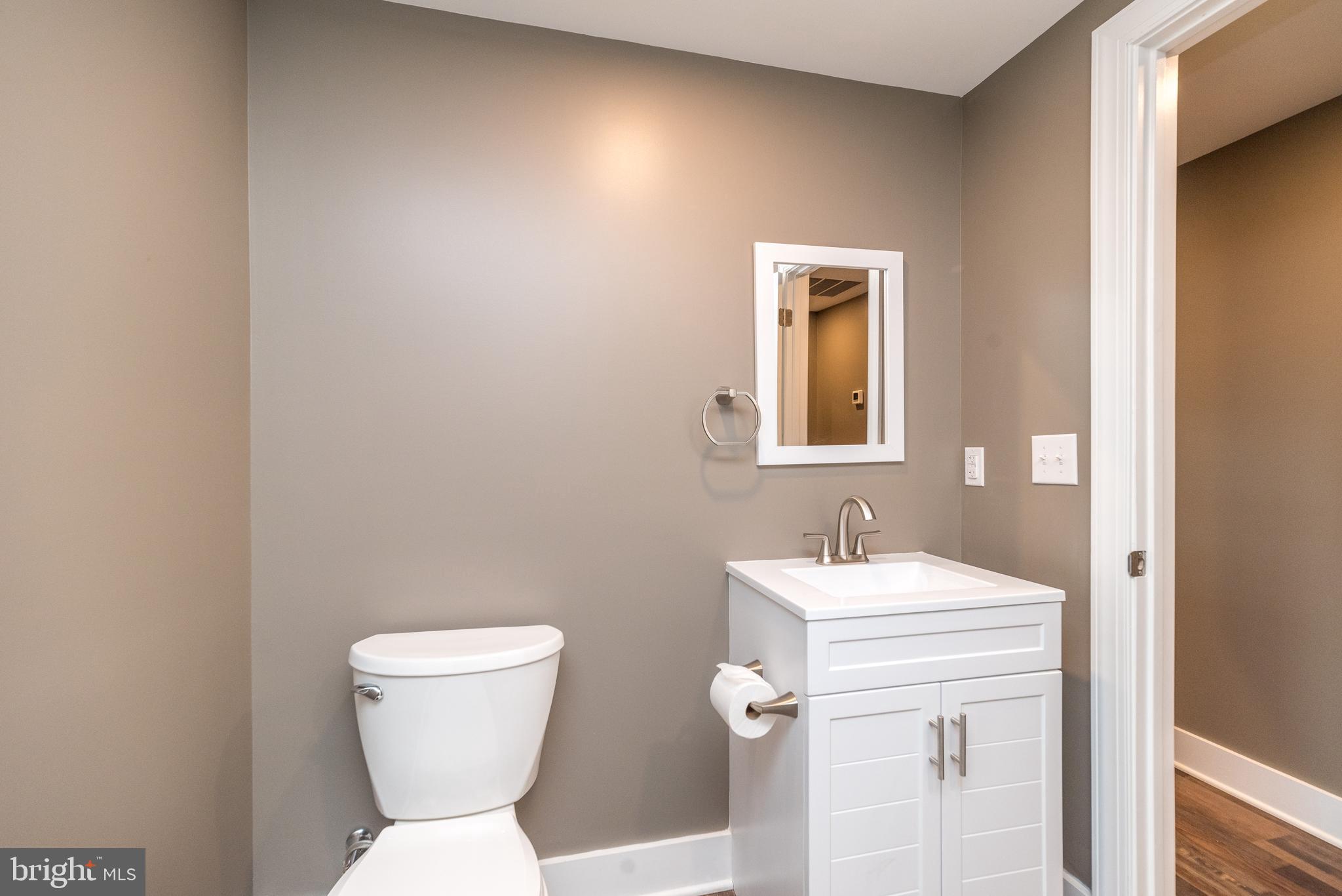 4844 Old Easton Road, Unit 2 Doylestown, PA 18902 - Photo 16 of 33 a bathroom with a toilet sink and mirror