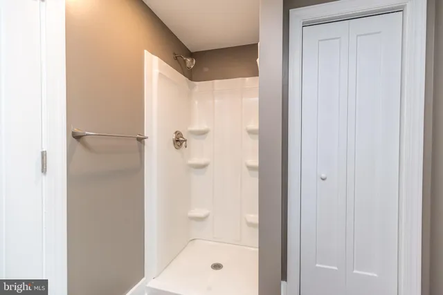 a bathroom with a glass shower door