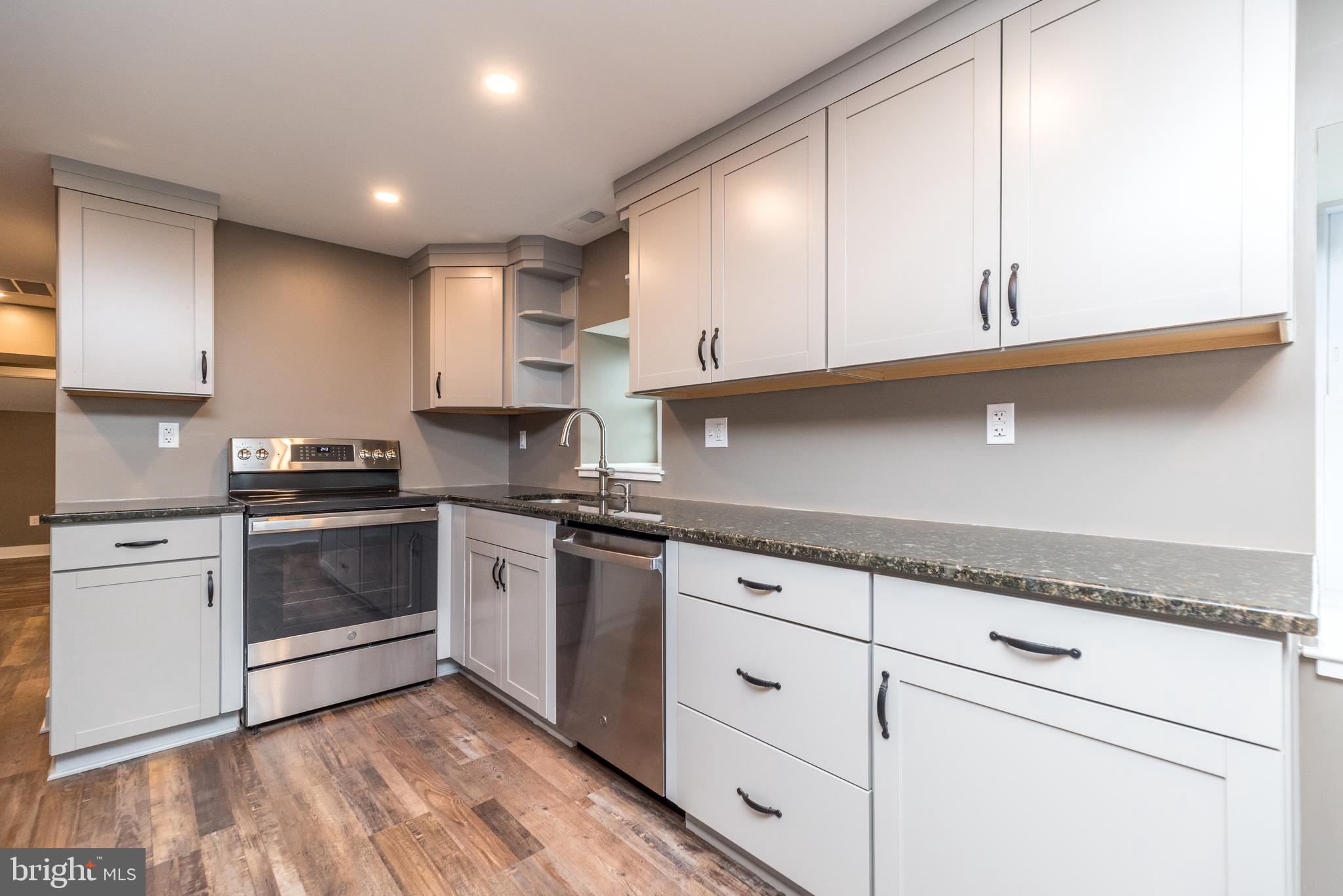 4844 Old Easton Road, Unit 2 Doylestown, PA 18902 - Photo 20 of 33 a kitchen with granite countertop white cabinets and white appliances