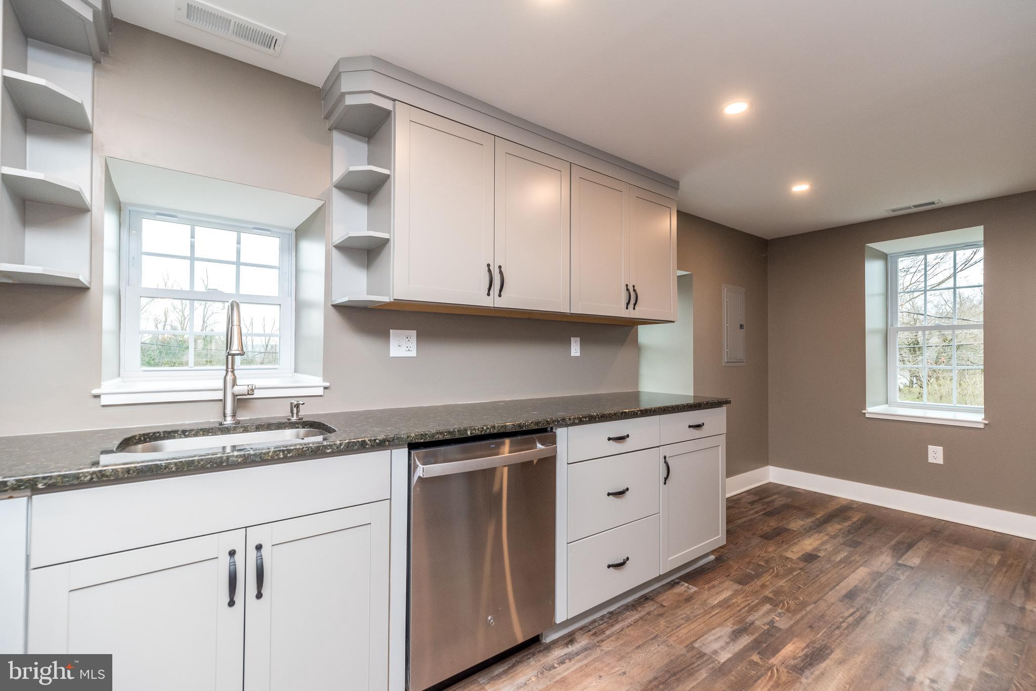 4844 Old Easton Road, Unit 2 Doylestown, PA 18902 - Photo 21 of 33 a kitchen with granite countertop white cabinets and a sink