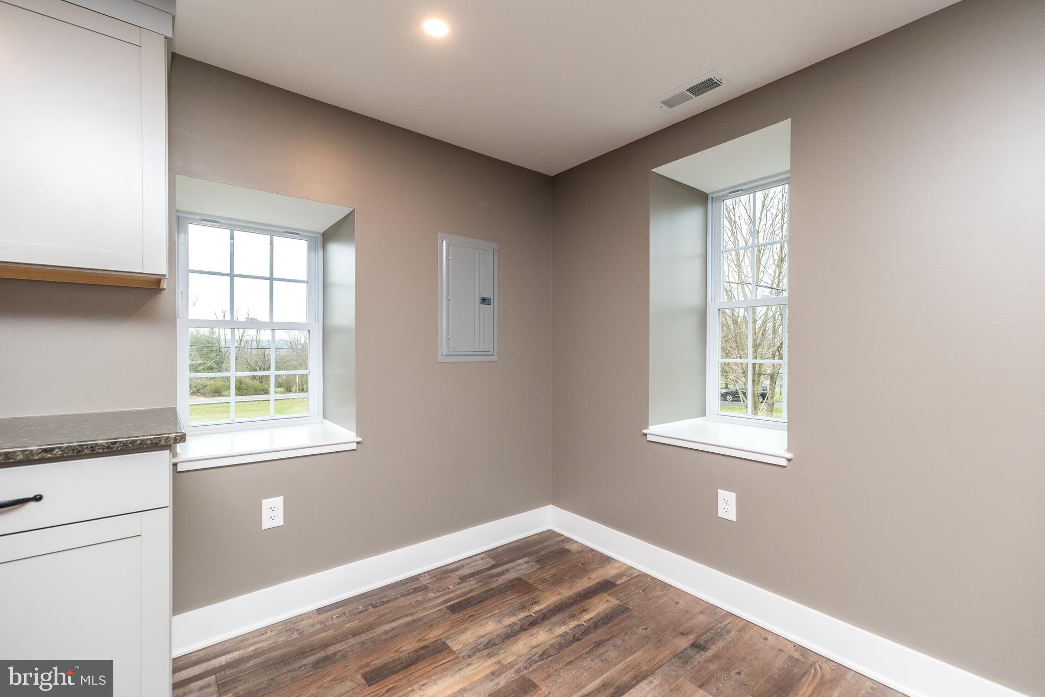 4844 Old Easton Road, Unit 2 Doylestown, PA 18902 - Photo 22 of 33 a view of an empty room with wooden floor and a window