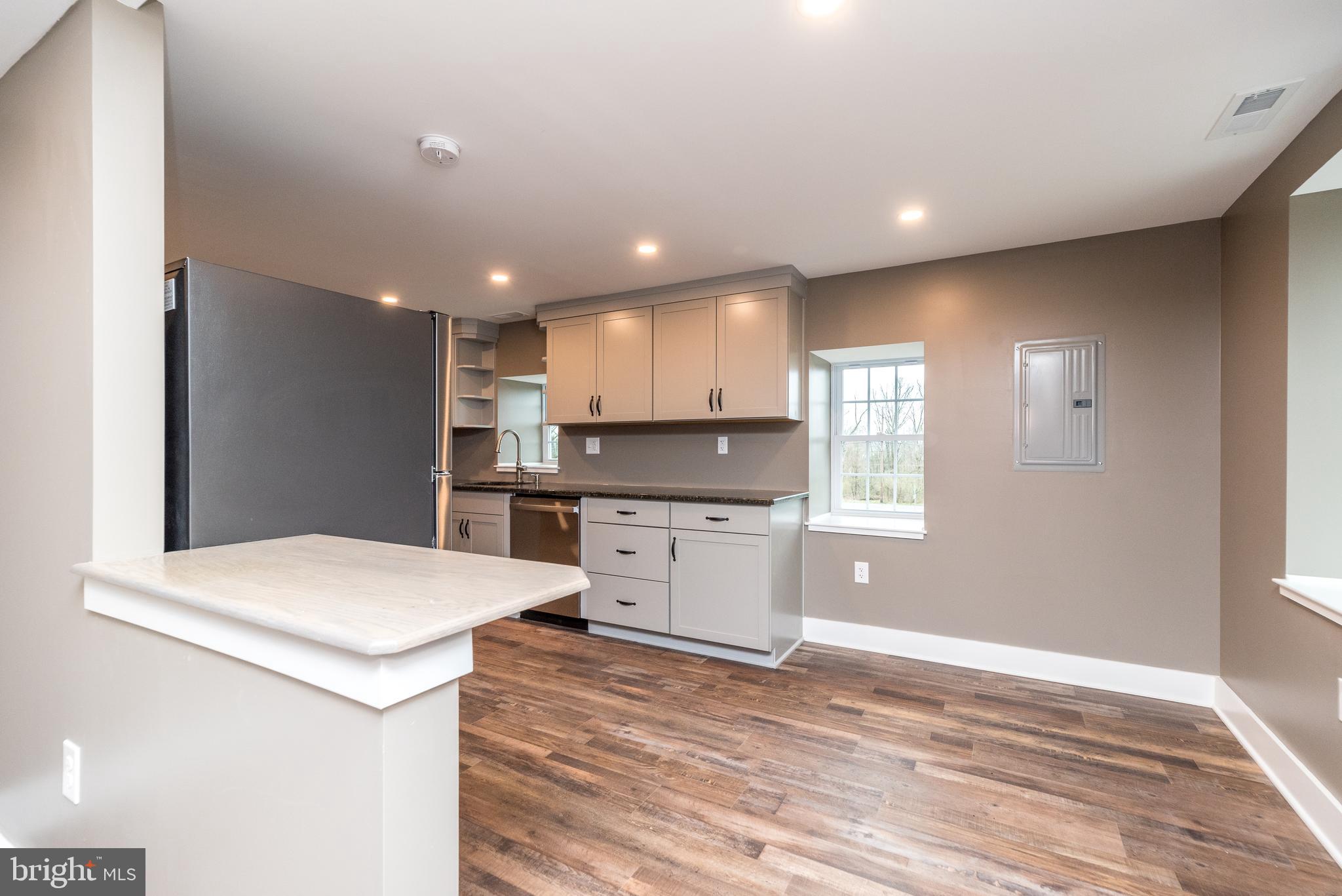 4844 Old Easton Road, Unit 2 Doylestown, PA 18902 - Photo 24 of 33 a kitchen with a refrigerator and a stove top oven
