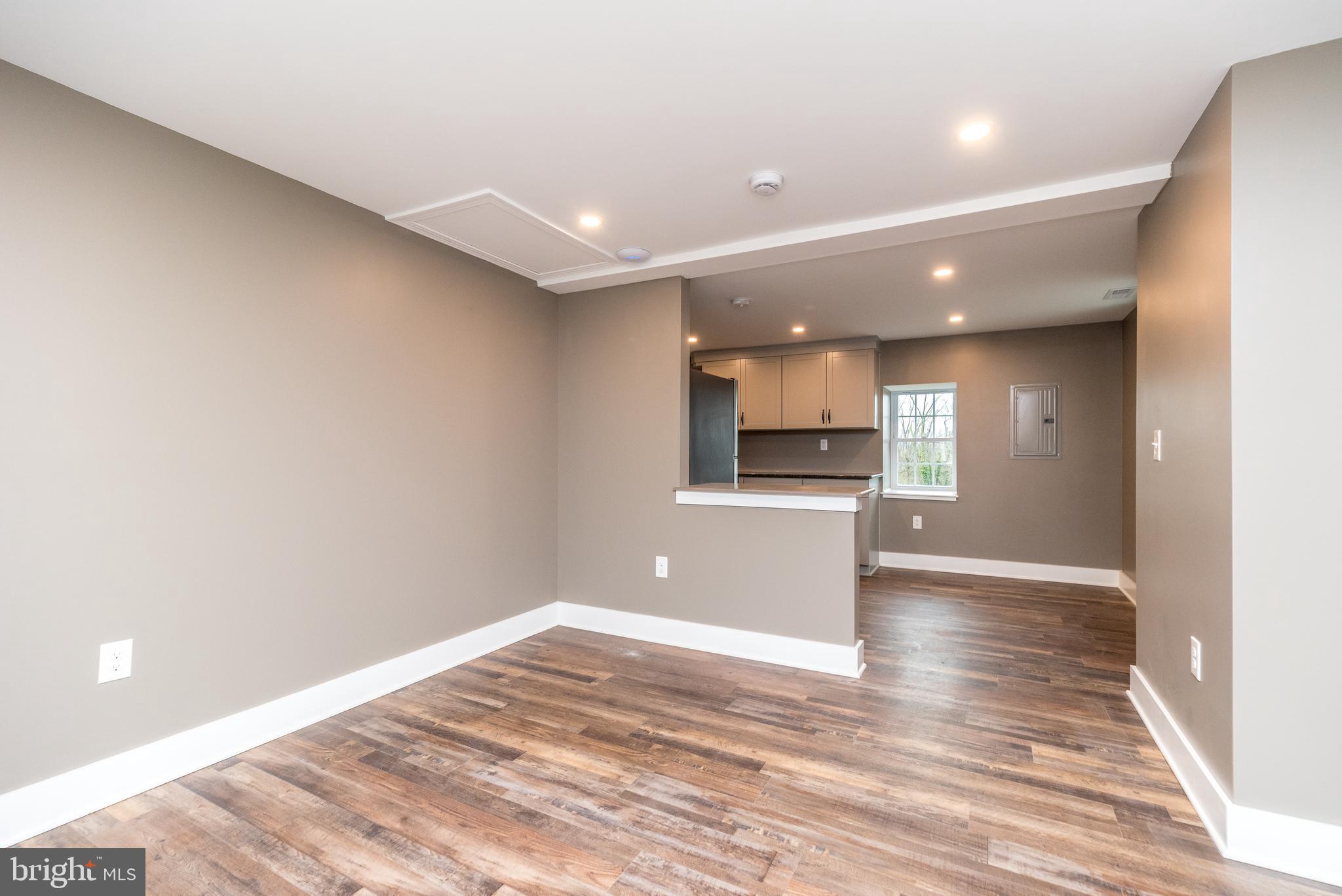 4844 Old Easton Road, Unit 2 Doylestown, PA 18902 - Photo 25 of 33 a view of kitchen and empty room with wooden floor