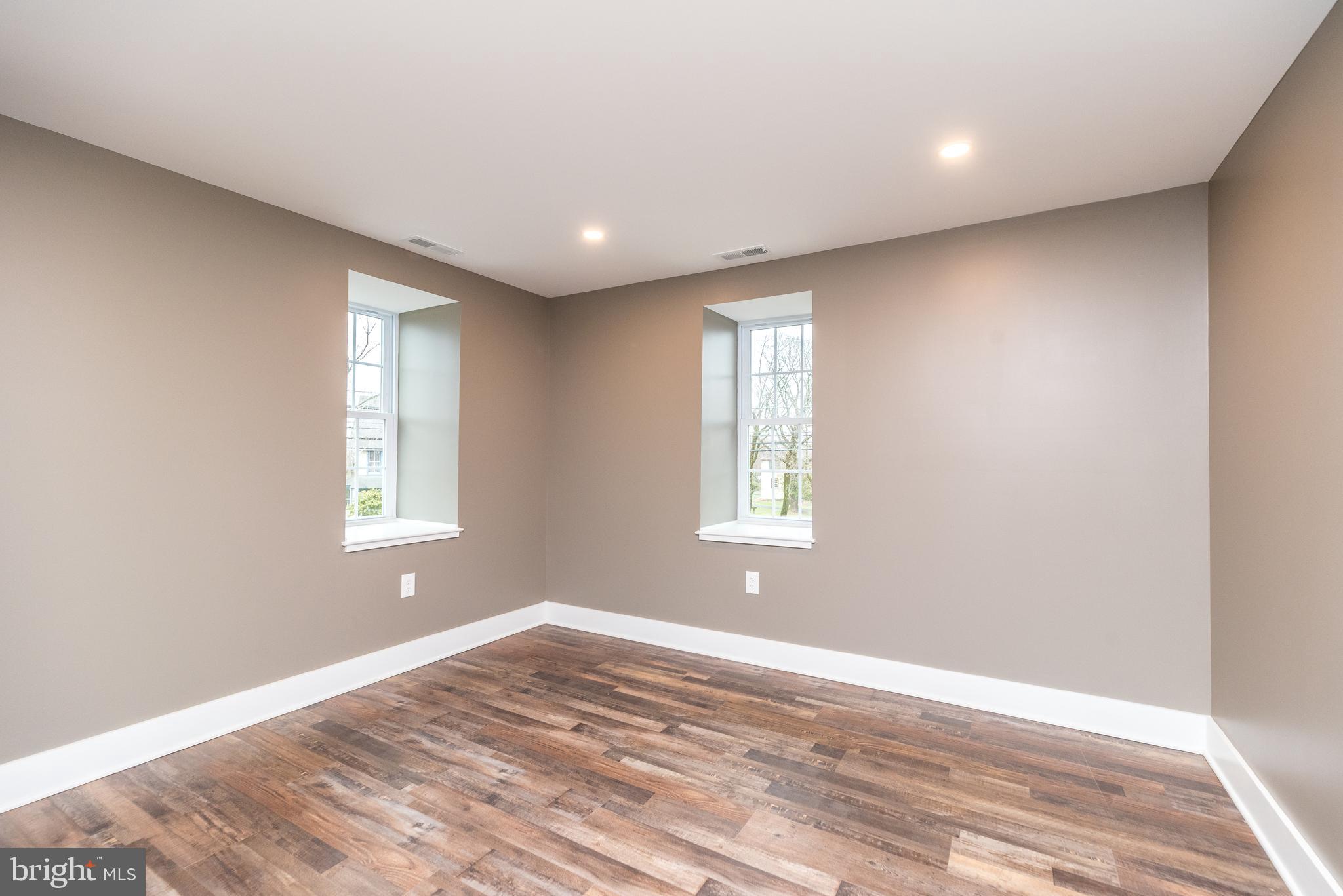 4844 Old Easton Road, Unit 2 Doylestown, PA 18902 - Photo 27 of 33 a view of empty room with wooden floor and fan