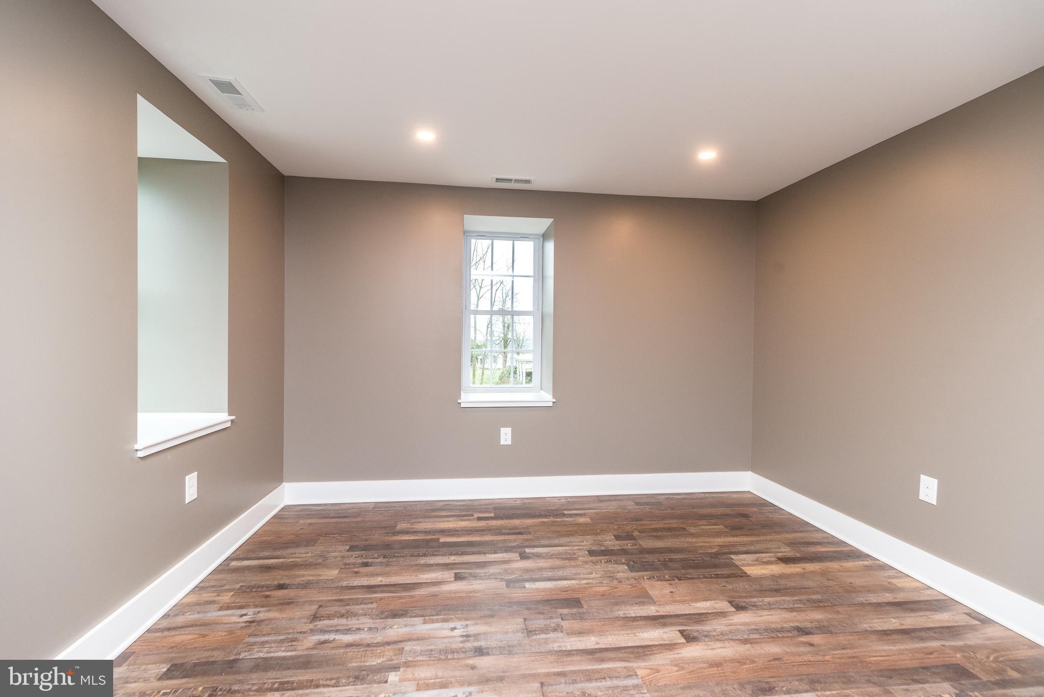 4844 Old Easton Road, Unit 2 Doylestown, PA 18902 - Photo 28 of 33 a view of empty room with wooden floor and fan
