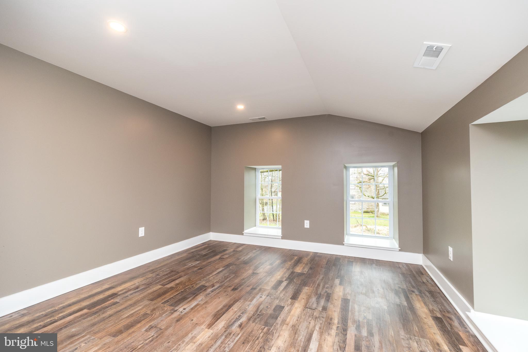 4844 Old Easton Road, Unit 2 Doylestown, PA 18902 - Photo 9 of 33 wooden floor in an empty room with a window