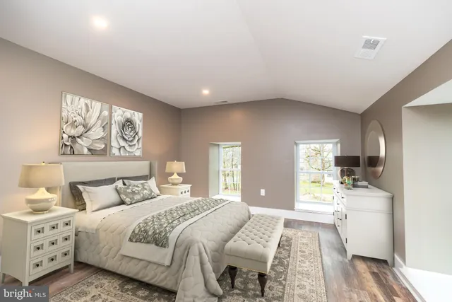 a bedroom with a large bed and a couch