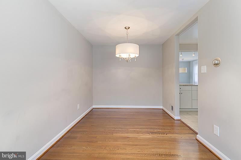 12912 Holdridge Road Silver Spring, MD 20906 - Photo 16 of 25 a view of empty room with wooden floor