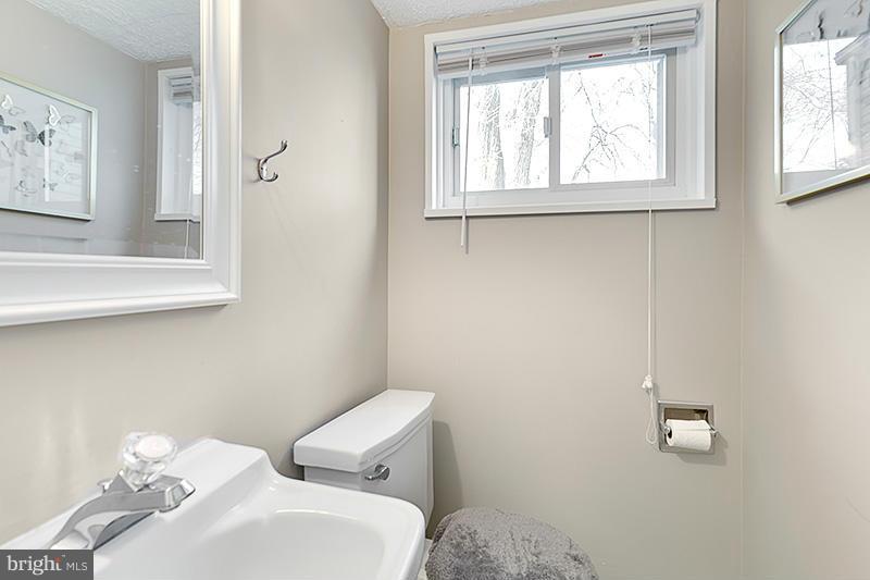 12912 Holdridge Road Silver Spring, MD 20906 - Photo 21 of 25 a bathroom with a toilet sink and window