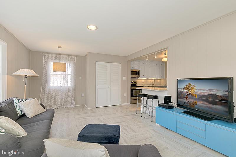 12912 Holdridge Road Silver Spring, MD 20906 - Photo 4 of 25 a living room with furniture and a flat screen tv