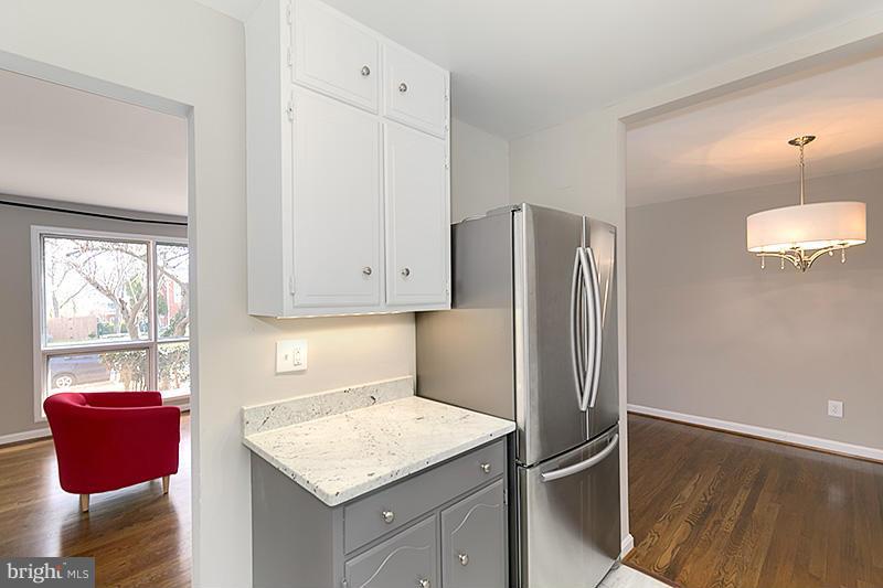 12912 Holdridge Road Silver Spring, MD 20906 - Photo 8 of 25 a kitchen with stainless steel appliances granite countertop a refrigerator and a sink