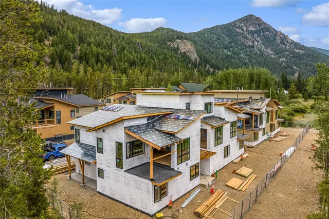 an aerial view of a house with a big yard