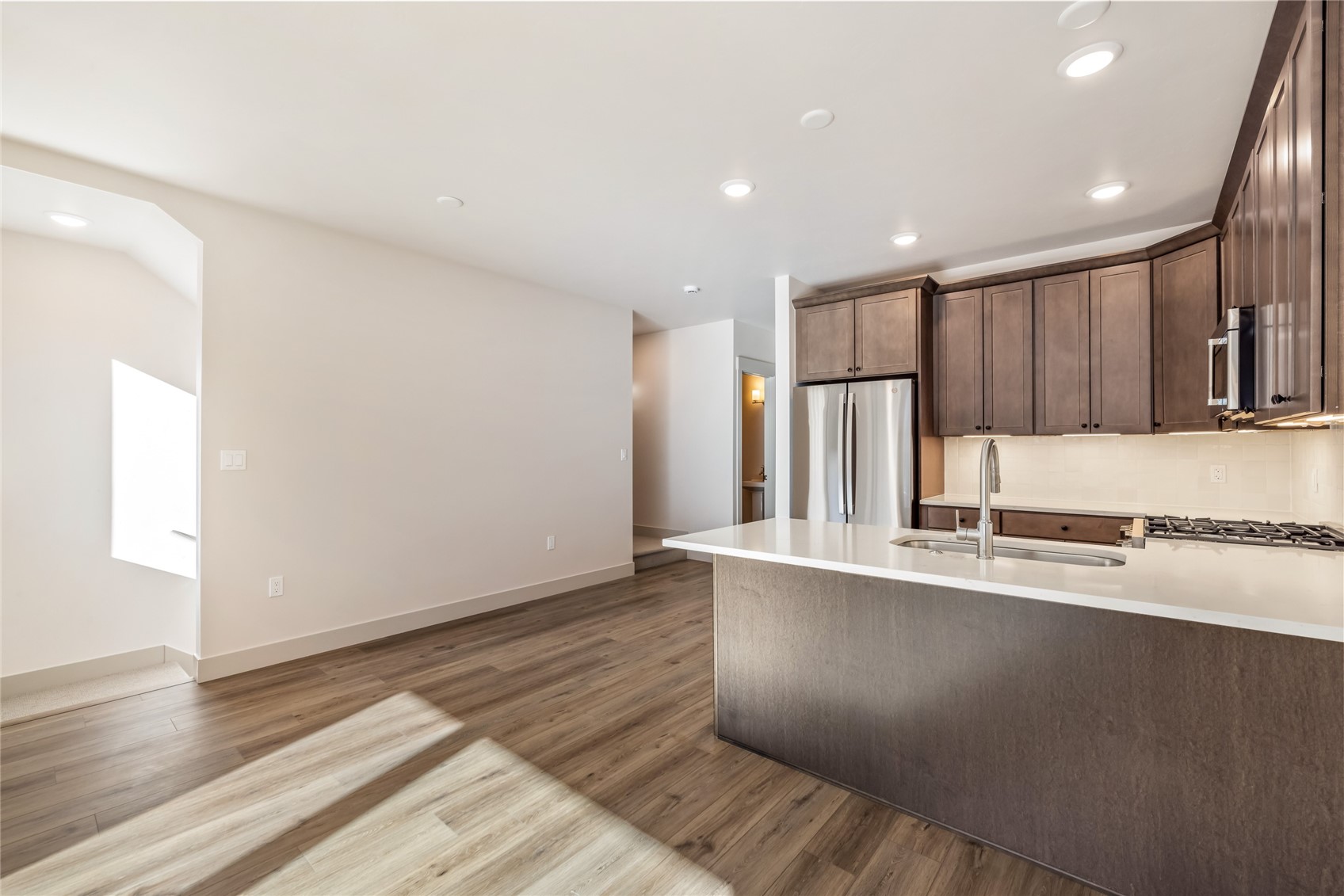 628 Montezuma Road, Unit D2 Keystone, CO 80435 - Photo 6 of 25 a large kitchen with stainless steel appliances a large counter top a stove and a refrigerator with wooden floor