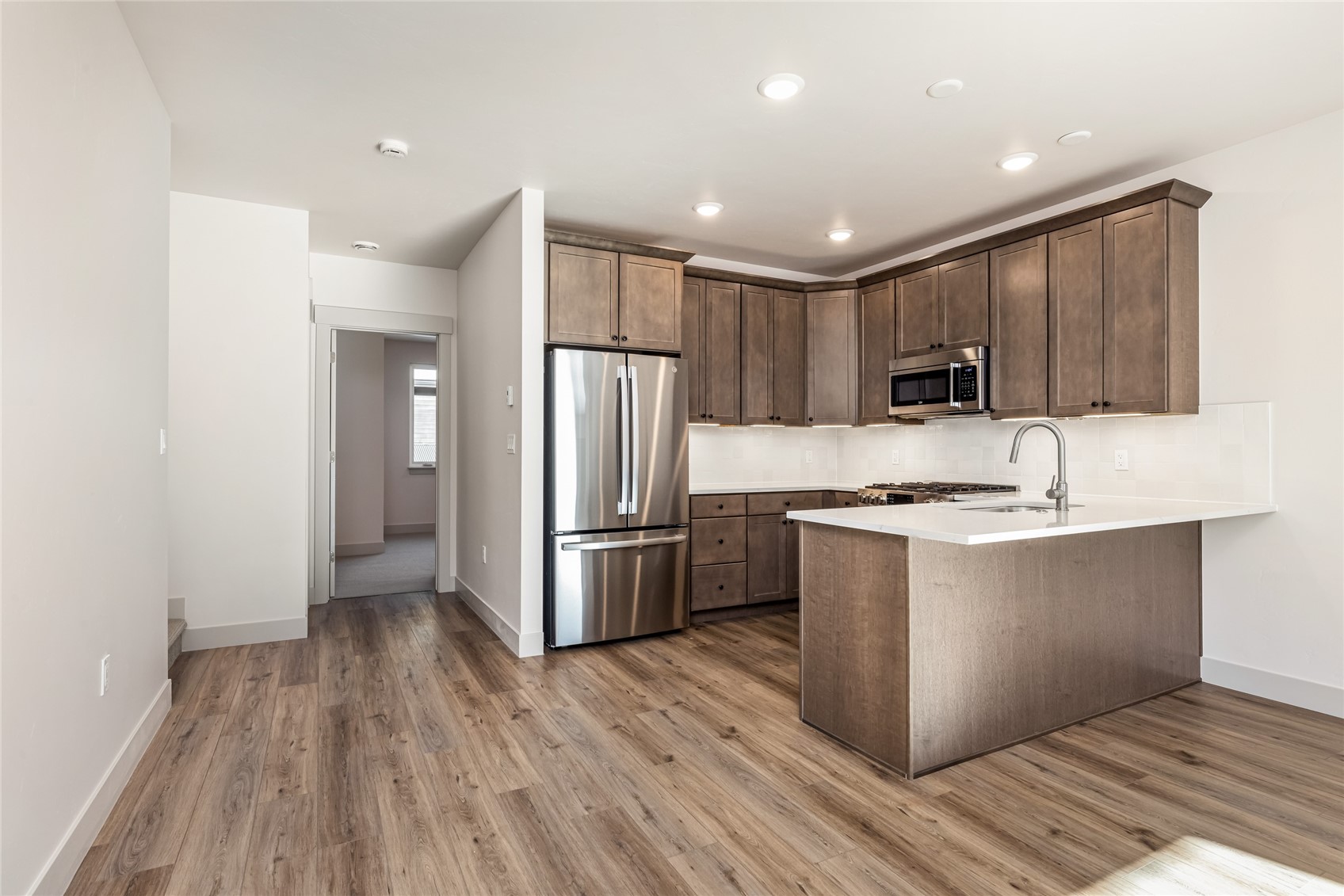 628 Montezuma Road, Unit D2 Keystone, CO 80435 - Photo 7 of 25 a kitchen with stainless steel appliances granite countertop a refrigerator a sink a stove a microwave and island with wooden floor