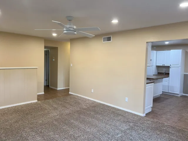 an empty room with a empty space and windows