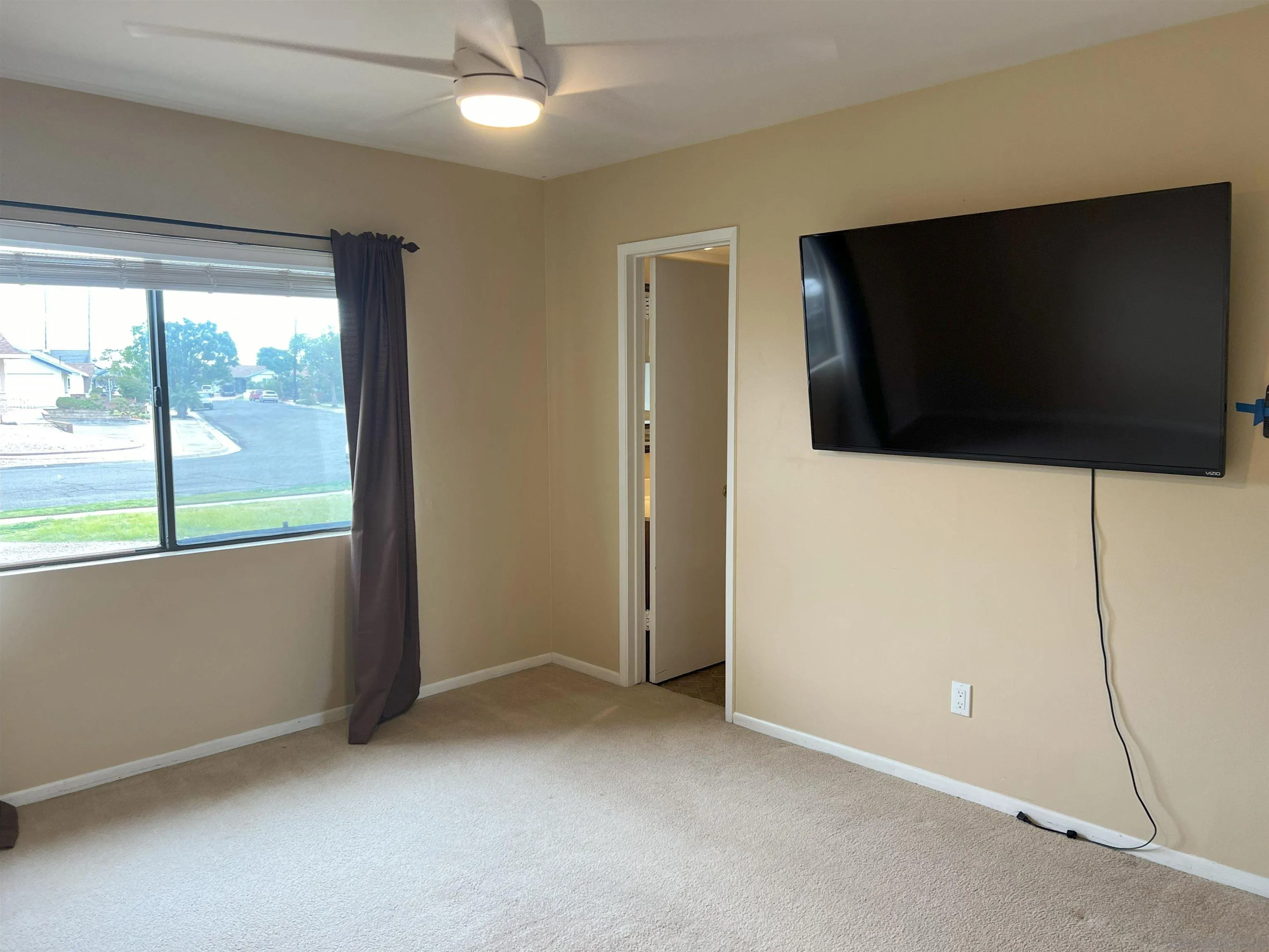 4054 Mt Barnard Avenue San Diego, CA 92111 - Photo 18 of 55 a view of an empty room with a flat screen tv